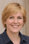 Smiling blonde woman sharing a positive review of The Brain Song audio program.